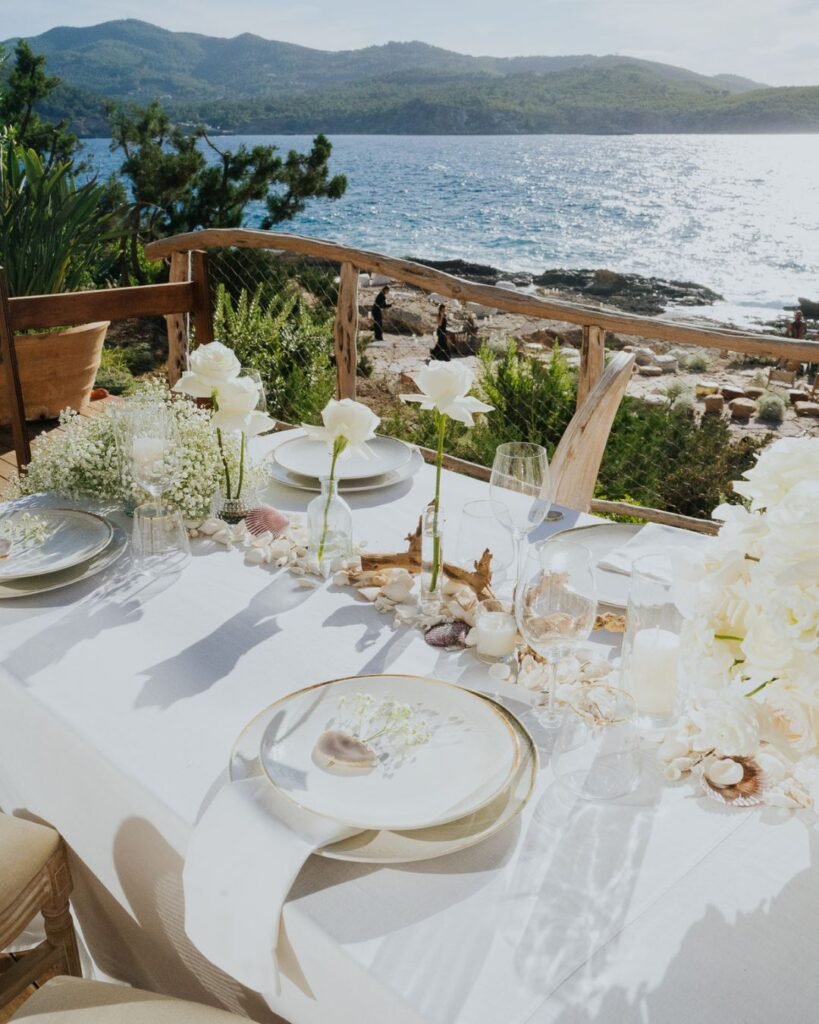 Seaside wedding table at Six Senses Ibiza with natural elements and ocean views.