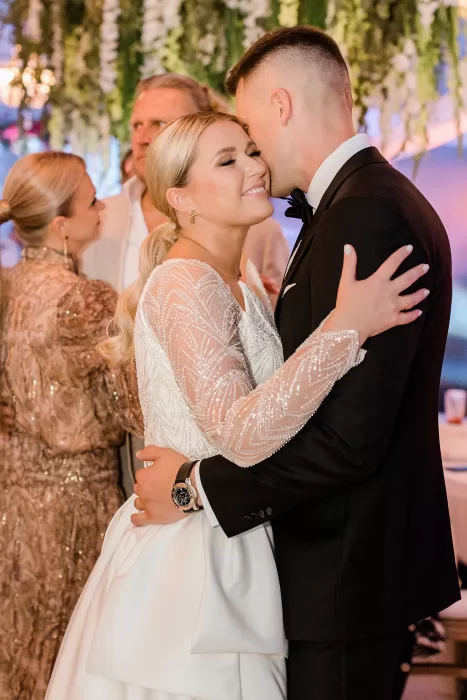 Bride and groom share an intimate dance under hanging greenery at Uzutrakio Dvaras wedding.