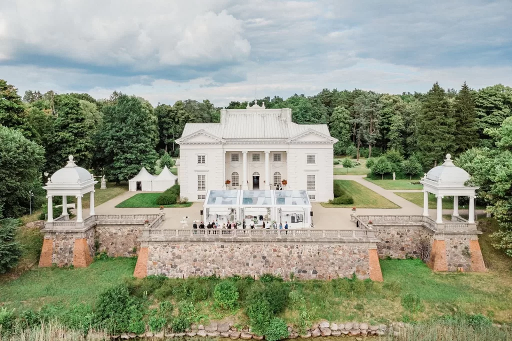 Aerial view of Uzutrakio Dvaras with elegant white marquee set against lush greenery