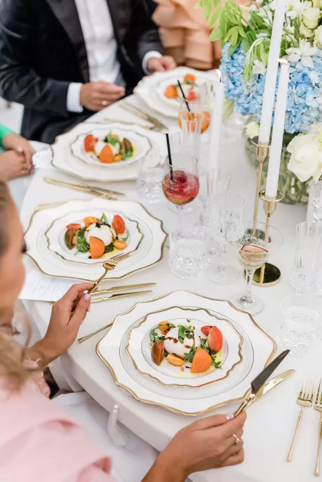 Wedding guests enjoying plated starters at elegant reception dinner at Uzutrakio Dvaras