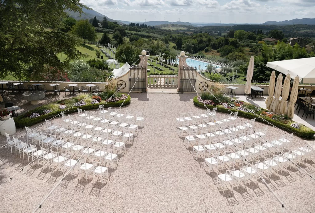 Elevated ceremony view showing symmetrical seating and lush countryside at Villa Cariola.