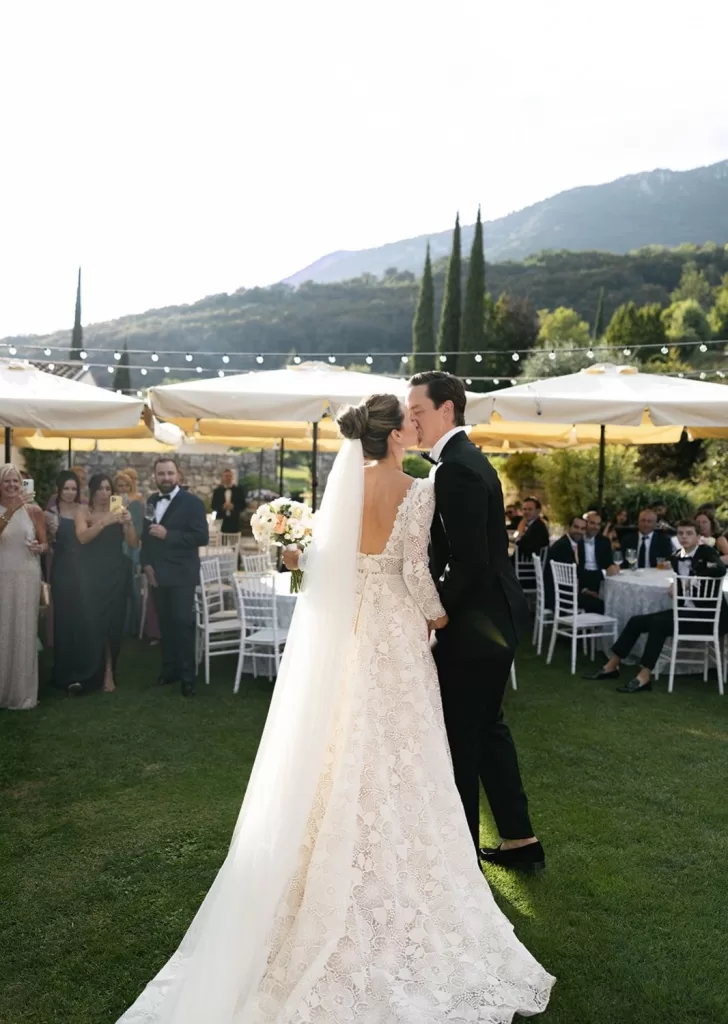 The newlyweds share their first dance outdoors at Villa Cariolla as guests look on with joy.