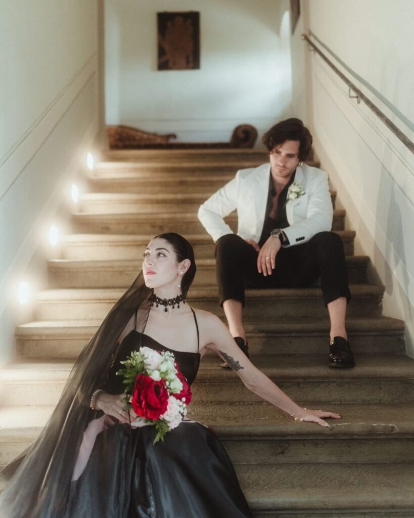 Bride and groom sit apart on the stone staircase of Villa Ivana, exuding quiet elegance and cinematic tension.