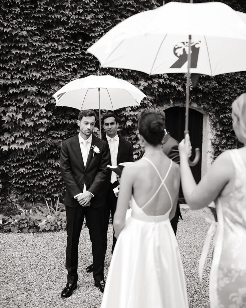 Groom listening to vows during outdoor ceremony at Château Rigaud.