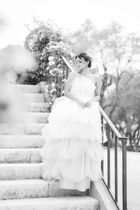 Dreamy shot of the bride descending the spiral stone staircase at Bastide du Roy, her tulle skirt trailing gracefully.