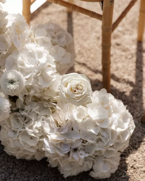 Elegant floral decor tied to ceremony chairs at Bastide du Roy, adding a touch of romance.