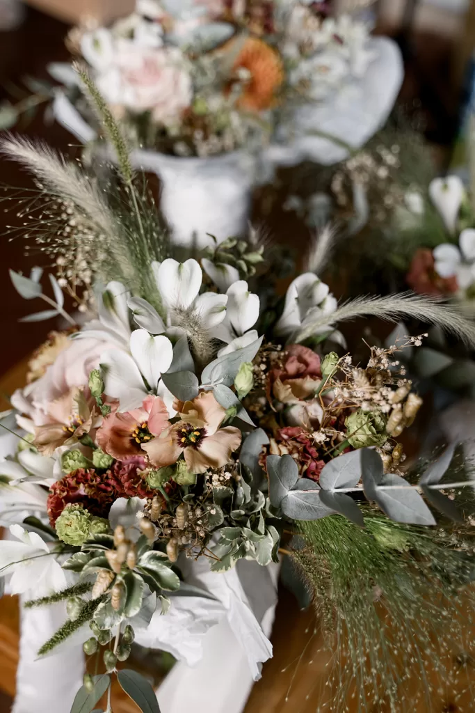 Romantic bridal bouquet with soft pinks, greens, and dried textures at Borgo Sant Ambrogio.