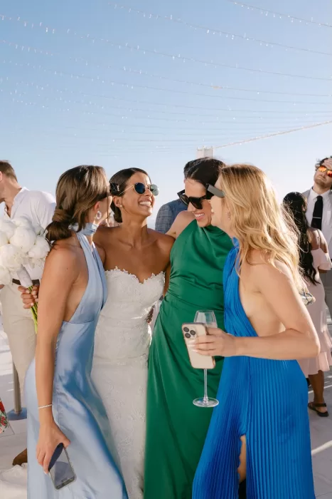 Bride laughing with friends before the ceremony at Rocabella Santorini