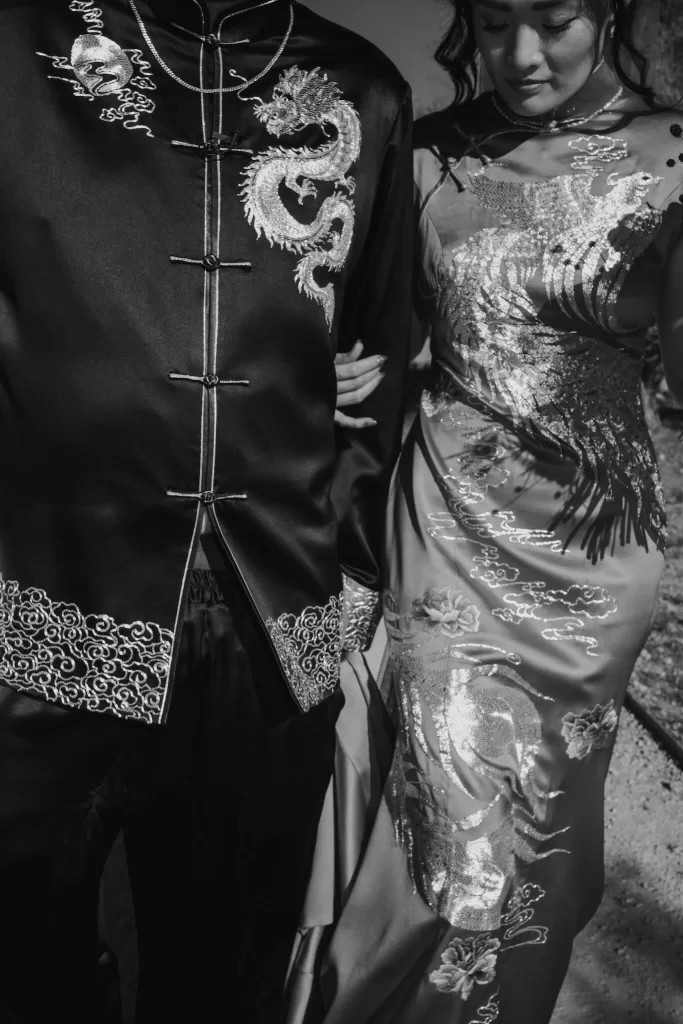Close-up of couple in traditional Chinese wedding attire at Ca Na Xica, with embroidered dragon and phoenix details.
