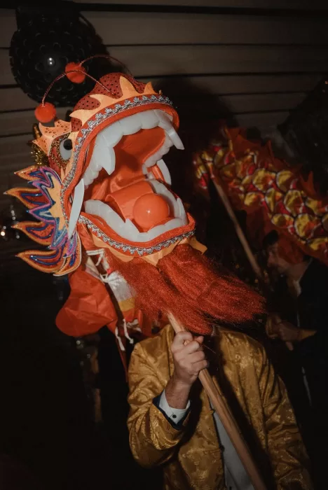 Detailed view of the ornate red and gold dragon head used in the traditional dance at Ca Na Xica wedding.