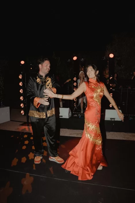 Bride and groom share their first dance under the stars at Ca Na Xica in elegant Chinese wedding attire.