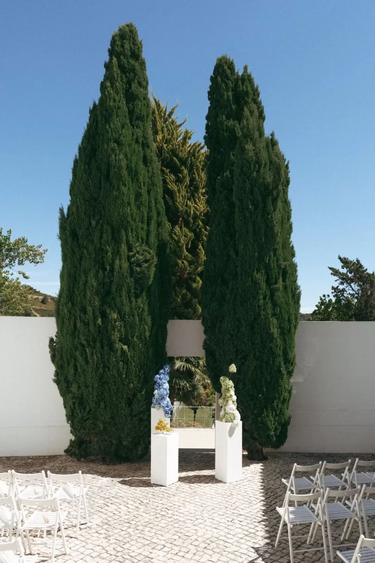 Ceremony setup at Casa Sacoto featuring minimalist seating and views of the surrounding greenery.