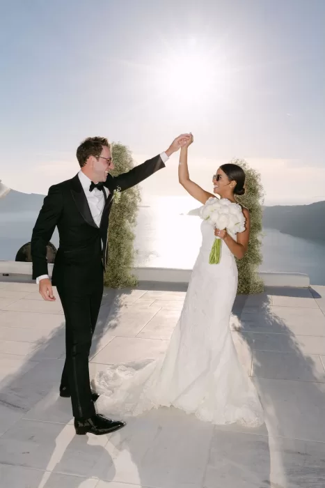 ride and groom’s romantic first dance under the fading Santorini sun