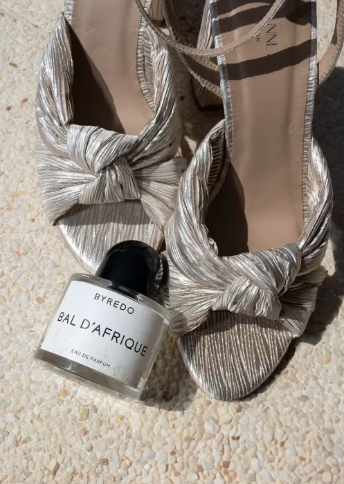 Metallic bridal heels with Byredo perfume photographed in the sun at Mas Torroella.
