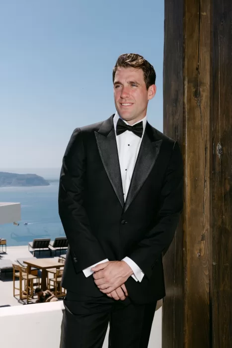 Groom portrait in natural light with Rocabella Santorini’s architectural details in the background