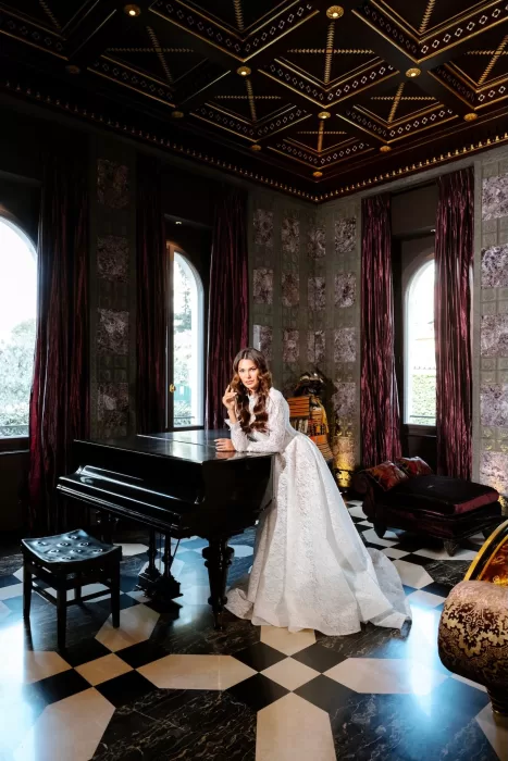 Bride seated by grand piano at Villa Clara