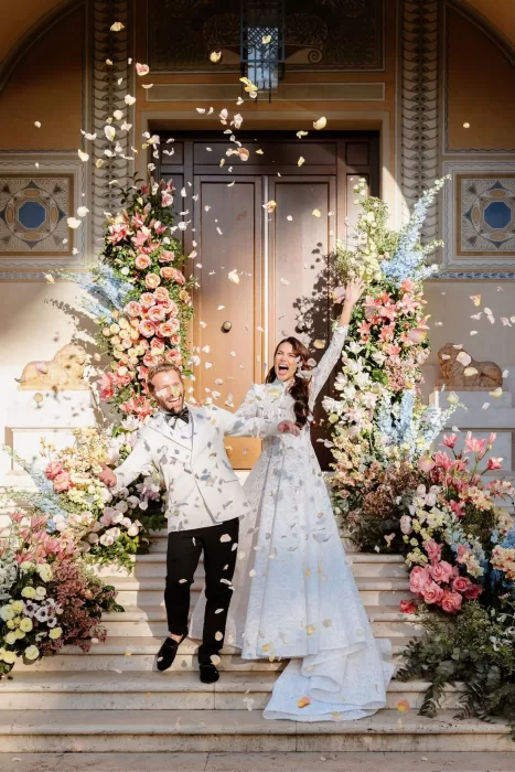Couple exits ceremony as petals fall at Villa Clara