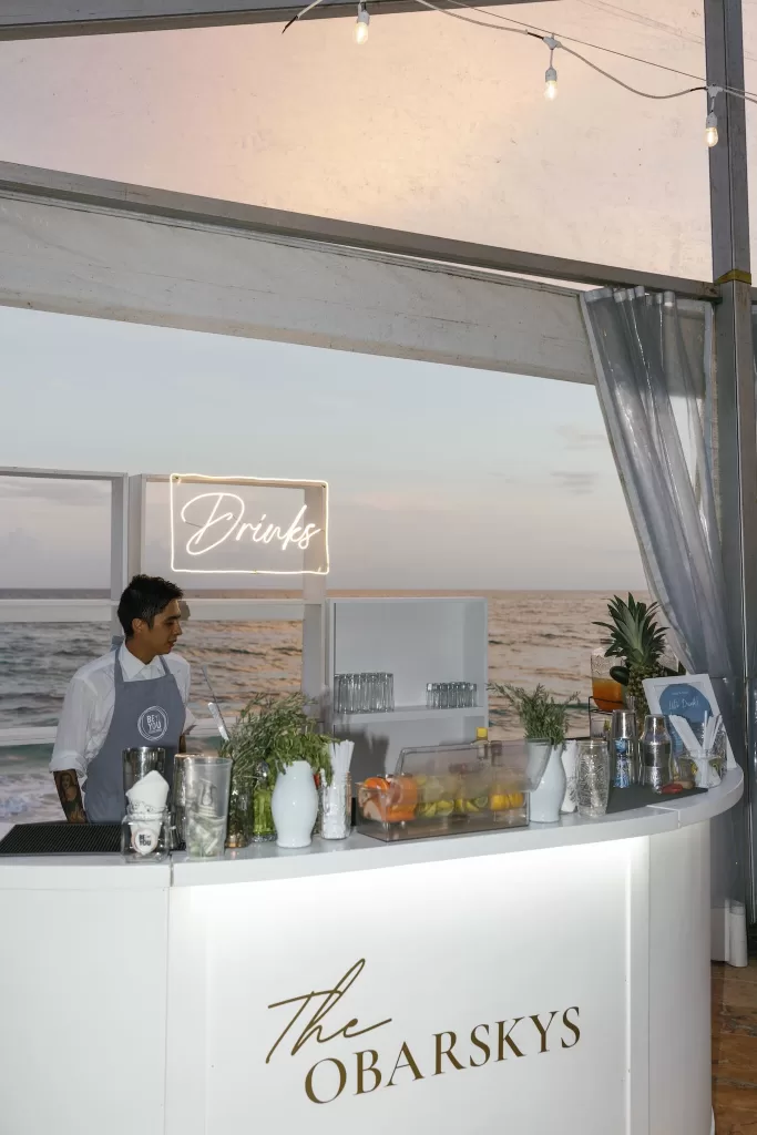 Modern wedding cocktail bar setup at Villa La Joya with ocean views and sunset lighting.