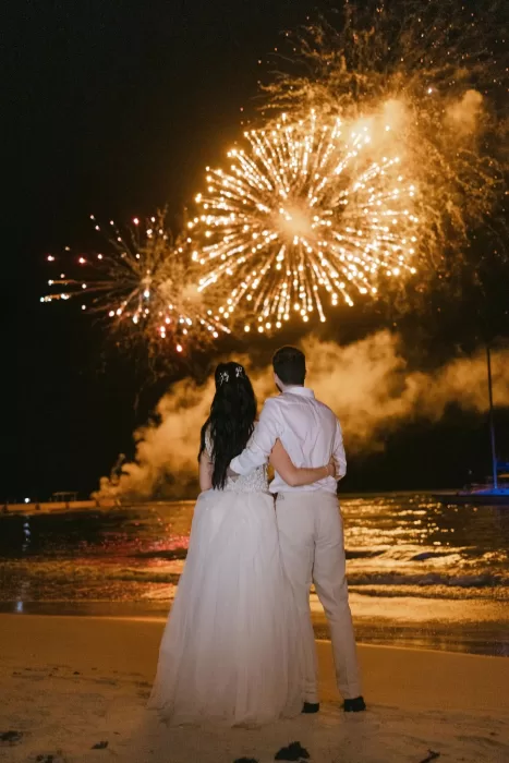 Bride and groom watching fireworks over the beach to end their wedding at Villa La Joya.