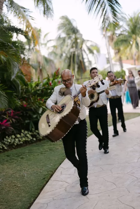 Traditional mariachi band walking through tropical garden path at Villa La Joya wedding.