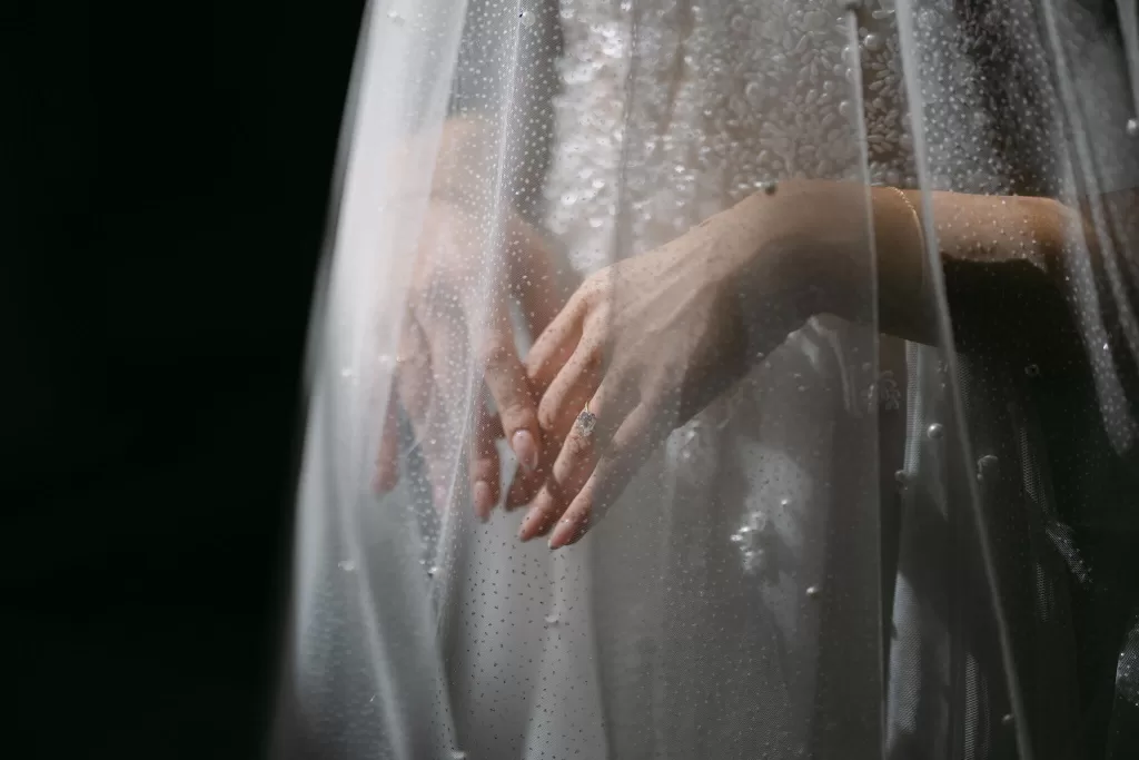 Bride’s hands and ring delicately shown through dotted sheer veil at Villa La Joya.