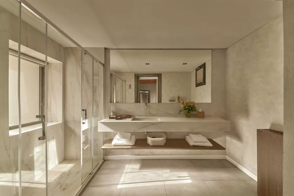 Sunlit bathroom with marble accents and floating vanity at Cigarral de las Mercedes