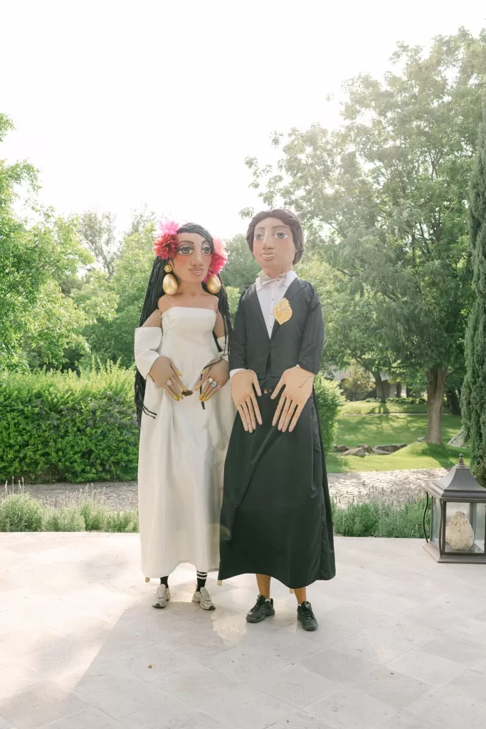 Artistic wedding puppets in garden setting at Luna Escondida, celebrating Mexican culture.