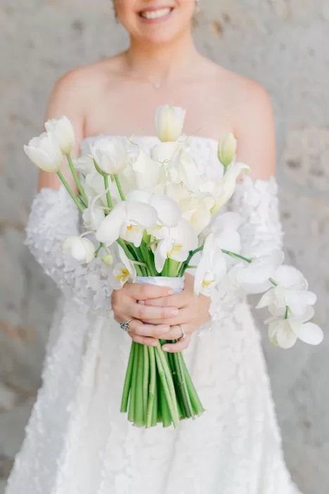 Close-up of elegant bridal bouquet with white tulips, calla lilies, and orchids at Luna Escondida