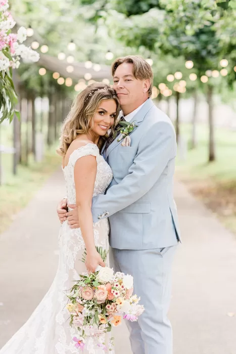 Intimate portrait of newlyweds smiling under string lights at Monte Pacis