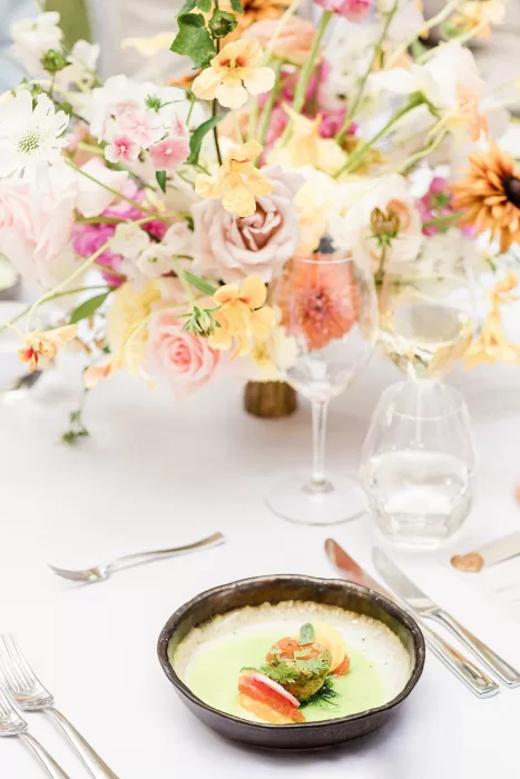 Gourmet wedding dish with floral backdrop at Monte Pacis celebration.