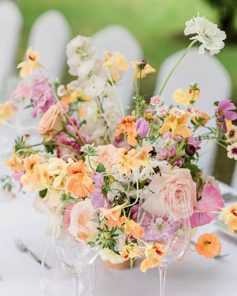 Elegant floral centrepiece with peach and lavender flowers on outdoor table at Monte Pacis