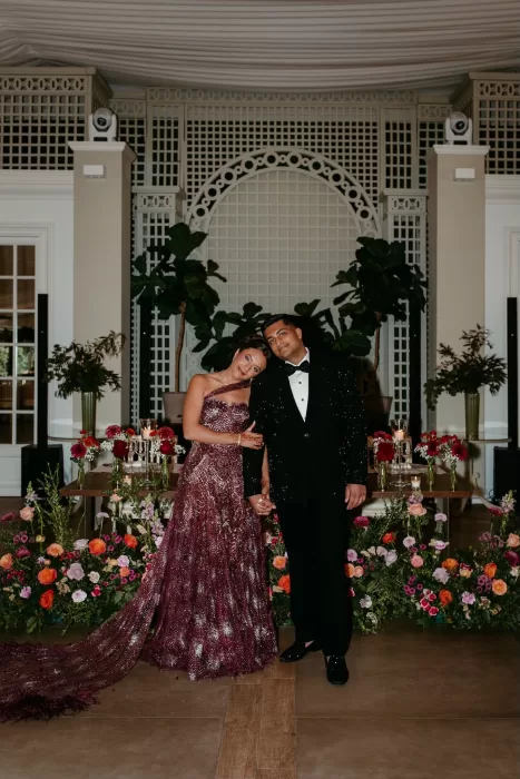 Bride and groom pose together during their floral-filled wedding reception at Cigarral de las Mercedes.