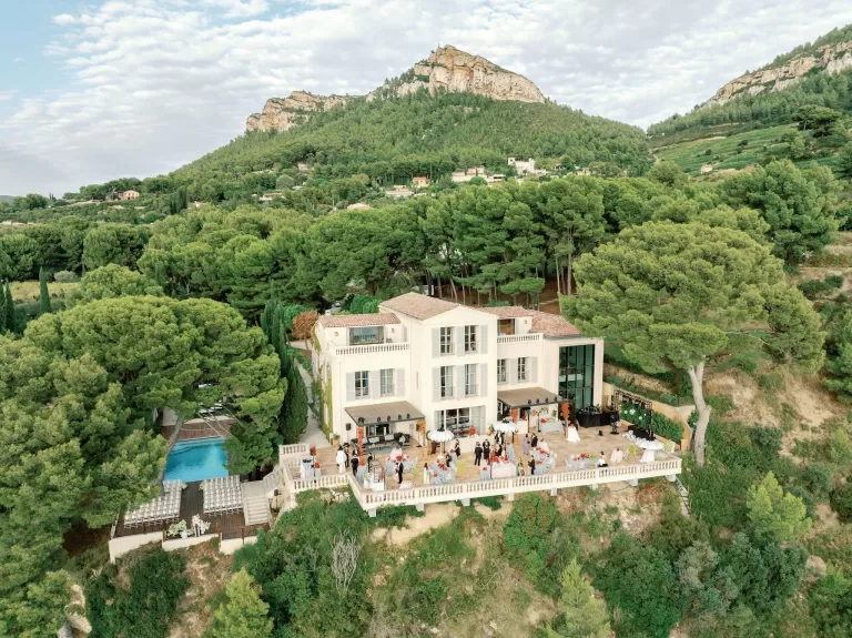 Aerial view of Domaine de Canaille surrounded by pine forest and hills during a wedding celebration