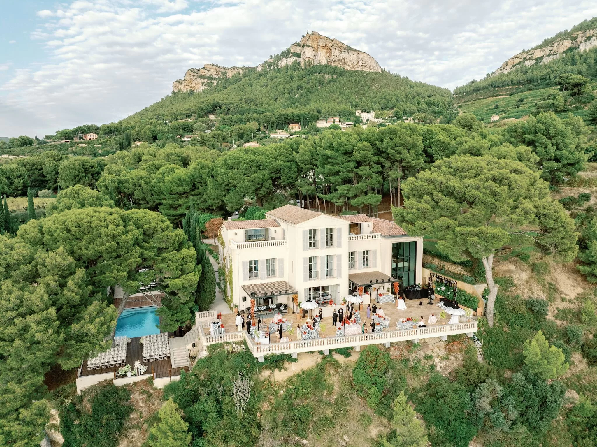Aerial view of Domaine de Canaille surrounded by pine forest and hills during a wedding celebration