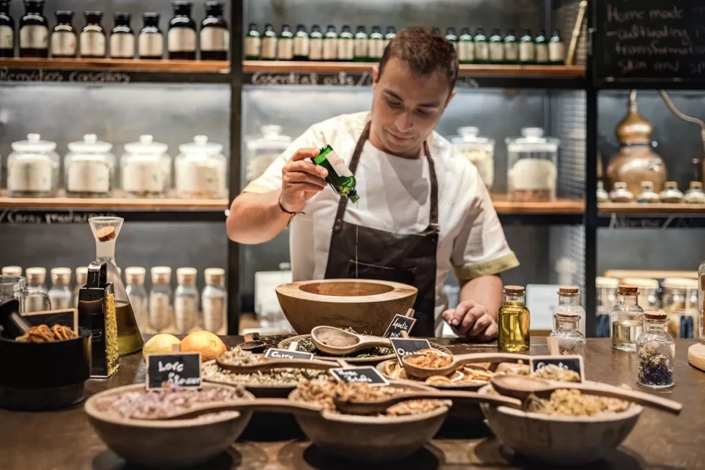 Herbal apothecary workshop at Six Senses Douro Valley with therapist preparing natural remedies.