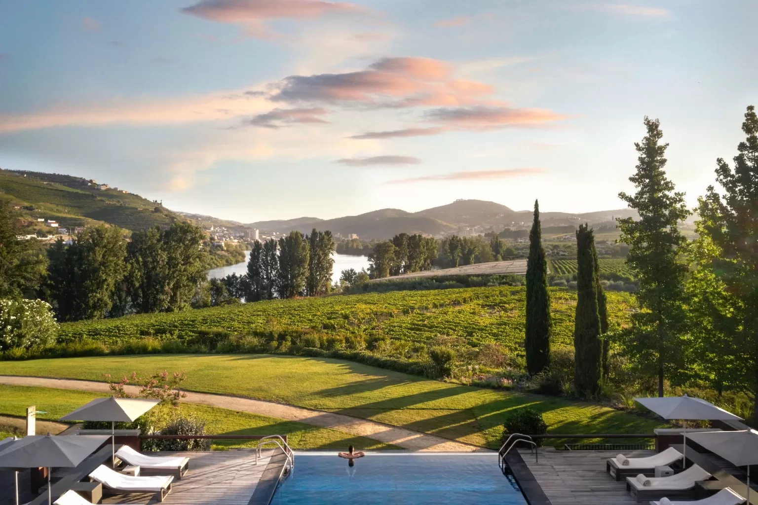 Infinity pool at Six Senses Douro Valley overlooking vineyards and the river valley.