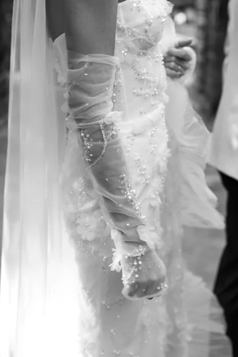 Close-up of bride’s beaded gown sleeve with delicate floral details at Beldi Country Club.