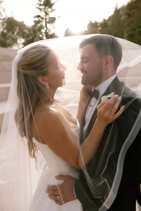 Romantic close-up of bride and groom embracing under the bridal veil at Cases de Sa Fonseca.