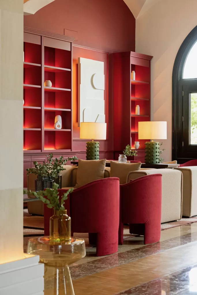 Stylish lounge with red accents and soft lighting inside Hospes Maricel & Spa.