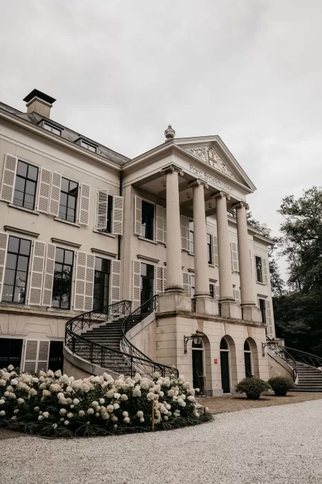 Architectural detail of Parc Broekhuizen with sweeping stairs and blooming hydrangeas.