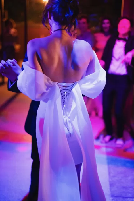 Bride and groom sharing their first dance under colorful lights at Six Senses Douro Valley.