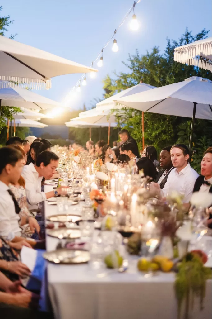 Candlelit outdoor wedding dinner with guests under string lights at Six Senses Douro Valley.