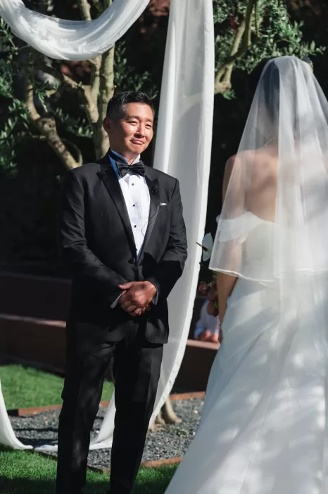 Groom smiling at the altar during outdoor wedding ceremony at Six Senses Douro Valley.