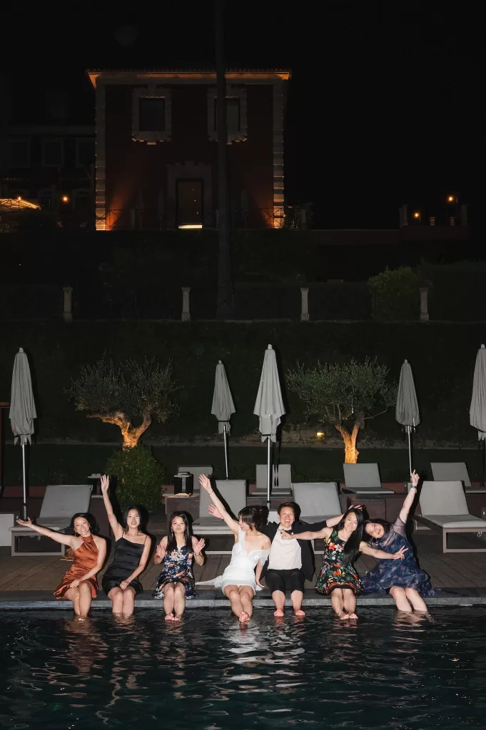 Wedding guests sitting by the pool at night celebrating at Six Senses Douro Valley.
