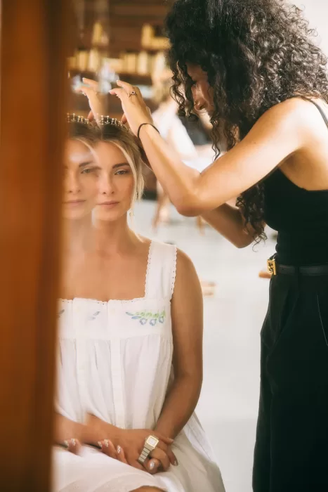 Bride having a jeweled tiara carefully placed in her hair at Villa Bossi.