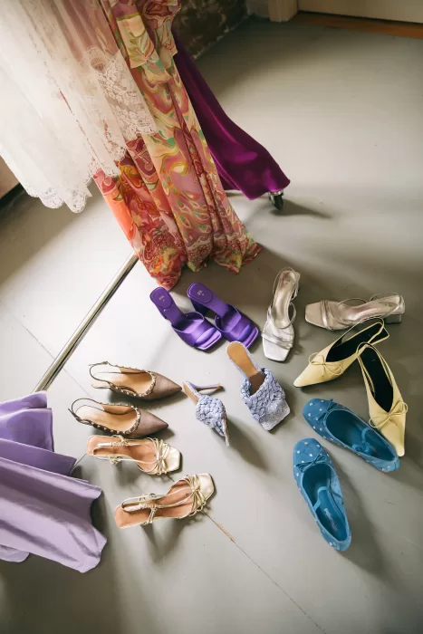 A colorful selection of bridal and bridesmaid shoes laid out on the floor at Villa Bossi.