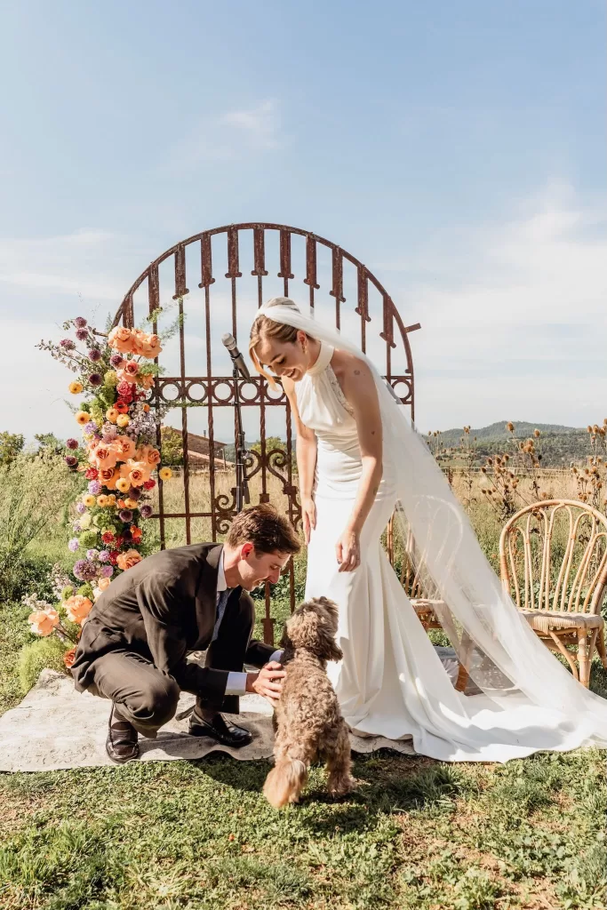 The bride and groom share a sweet moment with their dog during the ceremony at This Must Be The Place.
