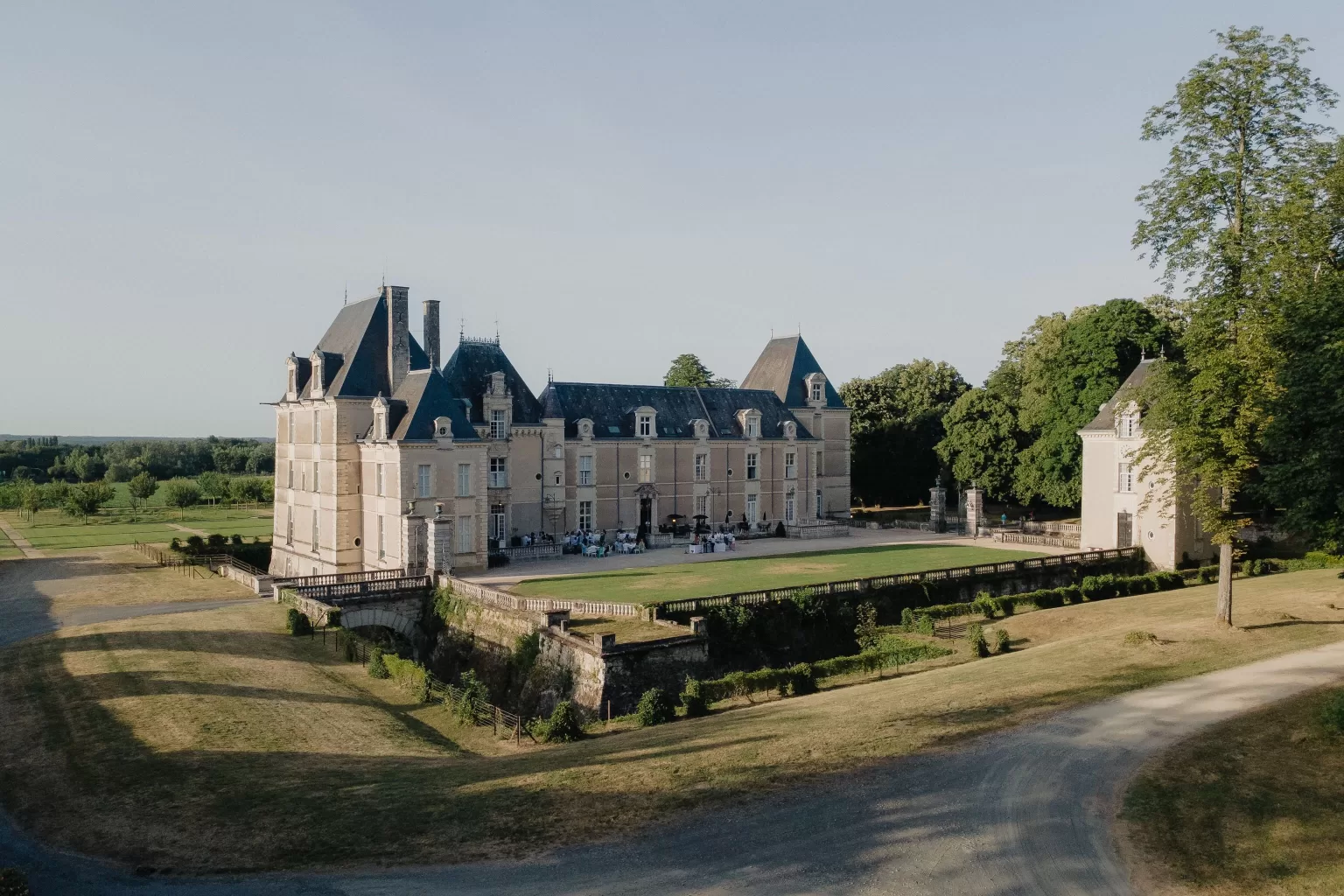Aerial view of Château de Jalesnes at golden hour, surrounded by parkland and countryside.