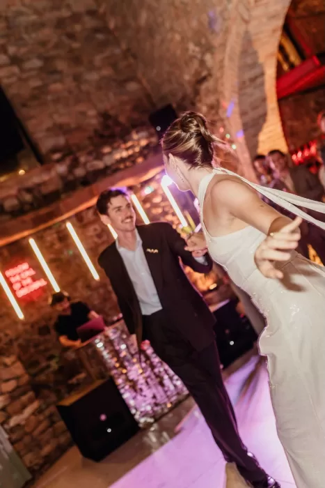 The couple share their joyful first dance inside the stone-walled party room at This Must Be The Place.