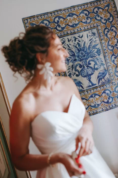 Bride standing beside traditional blue Portuguese tiles at Herdade do Peru, blending modern elegance with heritage charm.